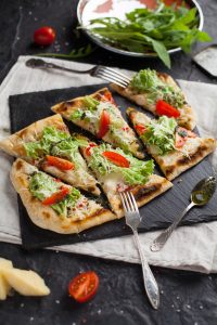 pizza with lettuce and tomato topping